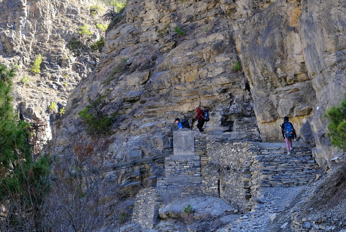With no progress possible along the rocky cliffs on the right bank, we cross the river on another suspension bridge