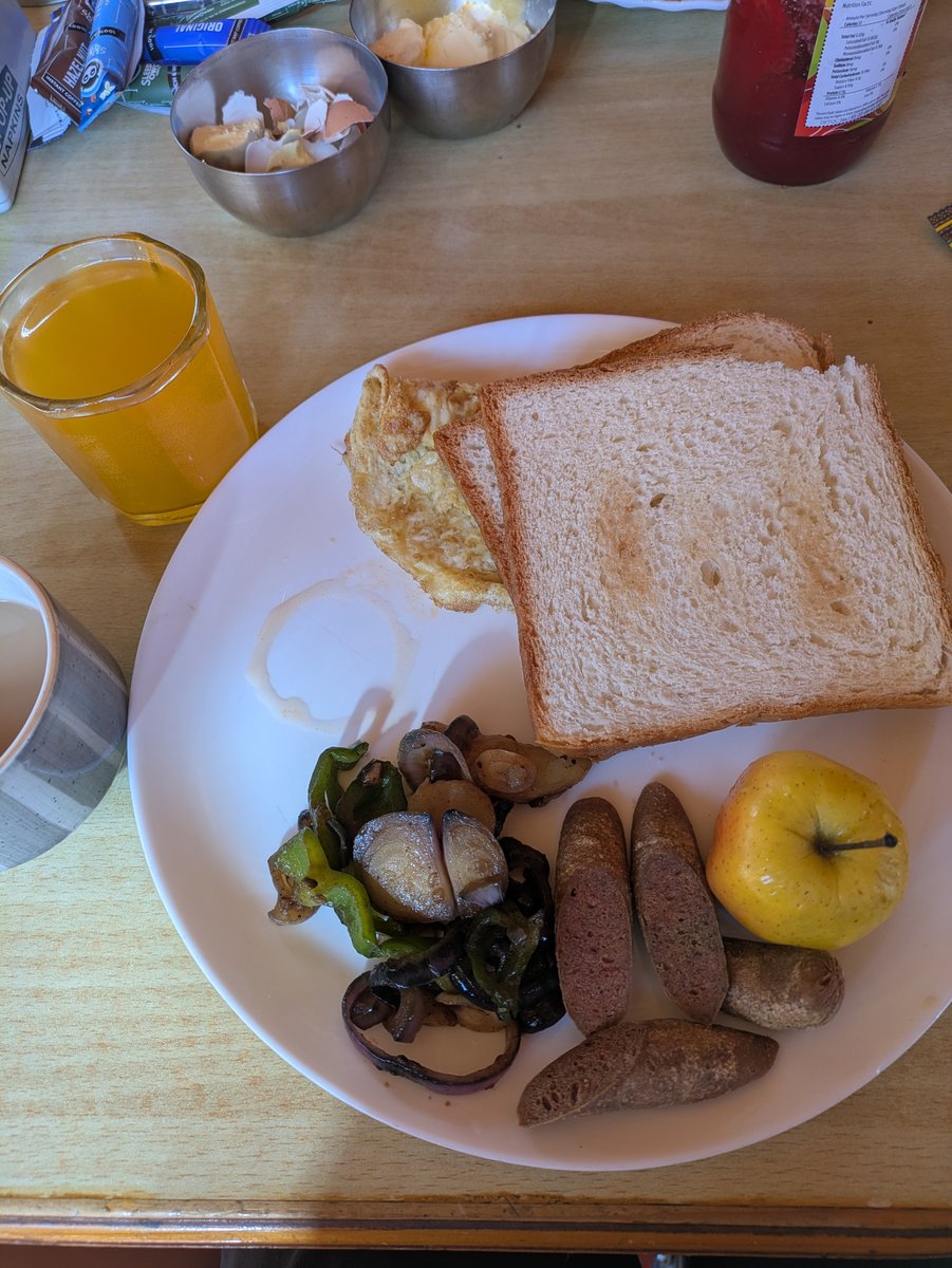 The special breakfast set bread, eggs, fried sausages and an apple