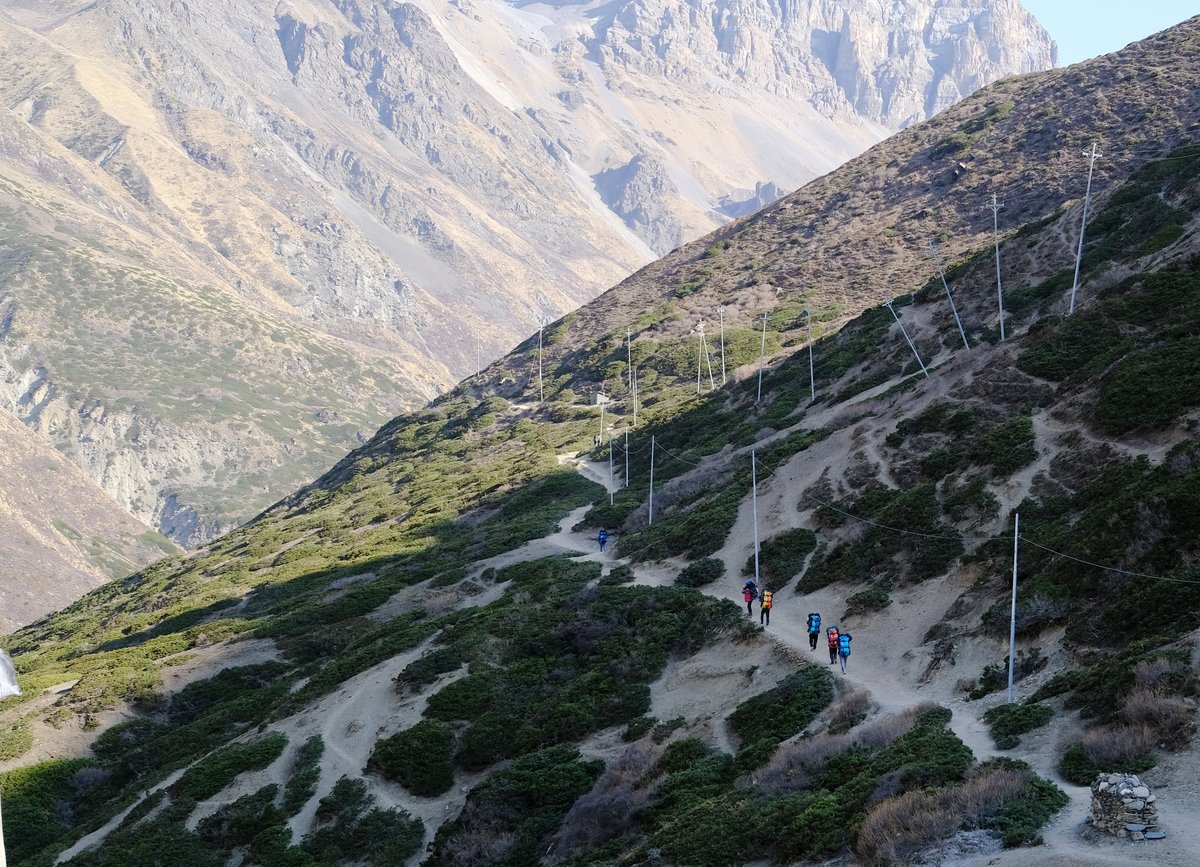 The porters carrying colorful duffel bags