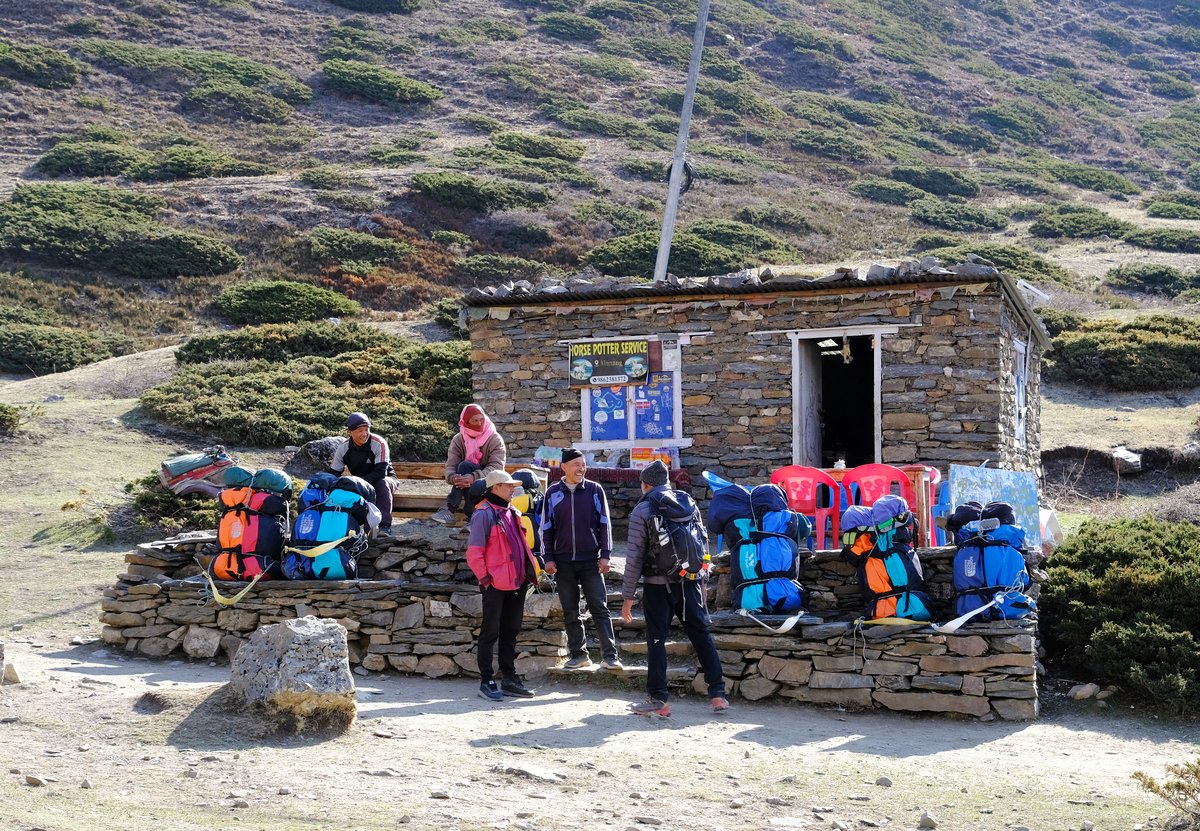 Even the local porters need breaks as the trail becomes a steady and steep climb